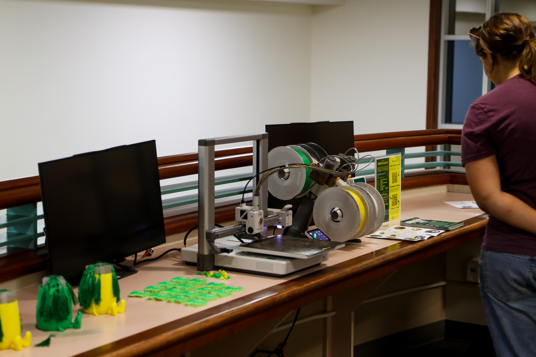 A student examines fabrication equipment in the pop-up makerspace.
