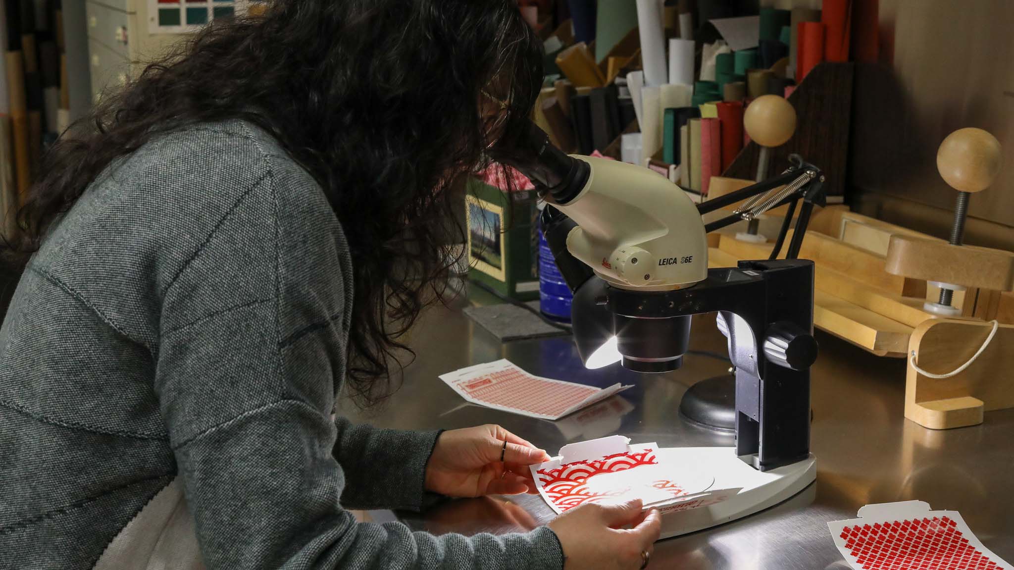 Victoria Wong peering into a microscope