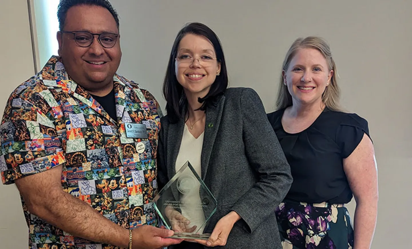 Gerard Sandoval (left), Alicia Salaz (center), and Evey Lennon (right) celebrate Salaz's recognition
