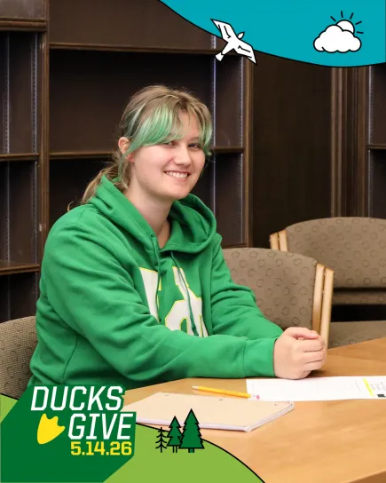 SCUA student worker Ava Tempelaere sitting at table in the Kesey Classroom