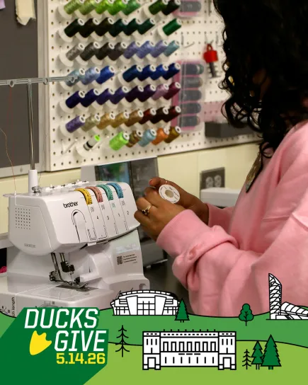 Student worker loading colorful thread into embroidery machine in the MakerSpace