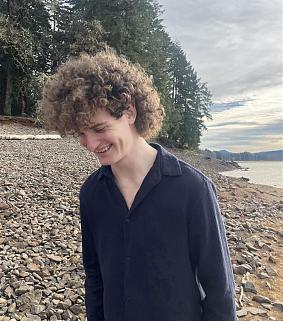 Joe Nowak standing on a rocky lake shore.