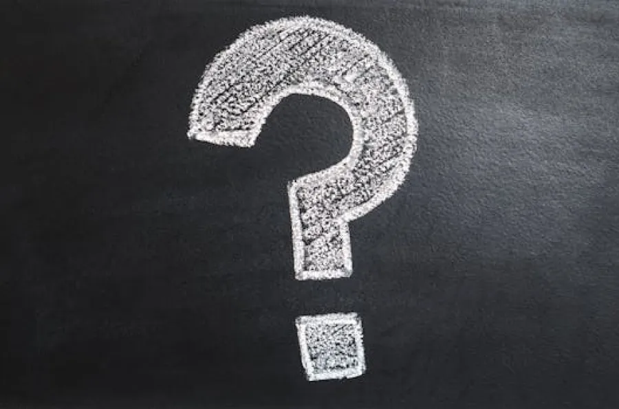 Question mark drawn with white chalk on a chalkboard. 