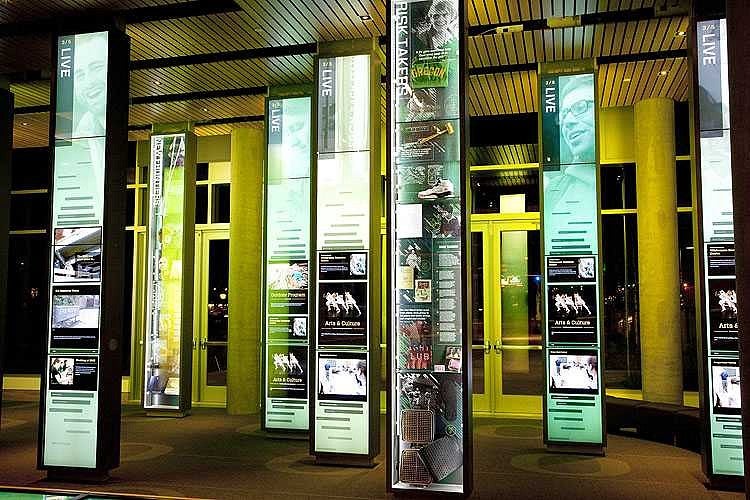 Visitors can use the fourteen-foot panels with touch-sensitive displays to explore than 1,000 UO-related stories through words, images, and video. Photograph by Michael McDermott