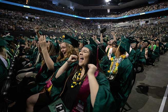 Graduates cheering during the commencement ceremony