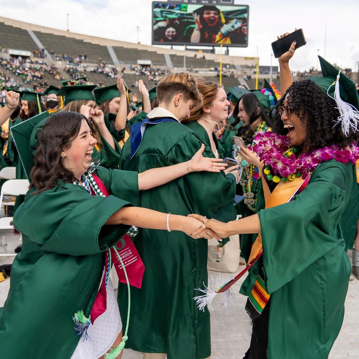 grad friends embrace