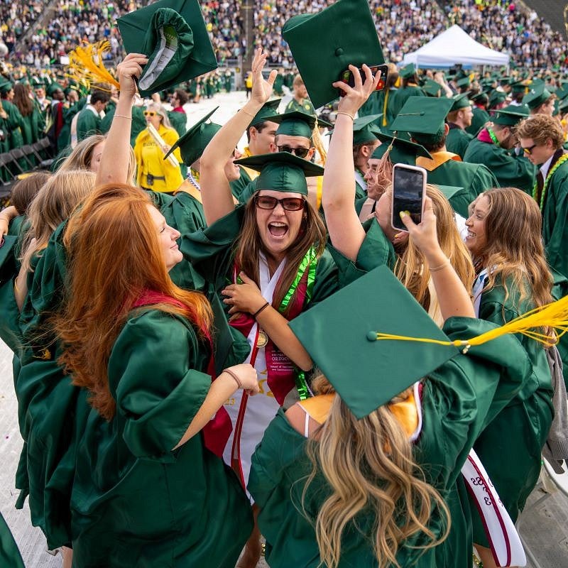 grad friends shout with joy