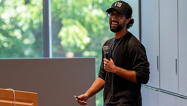 A young male entrepreneur give a presentation on his business