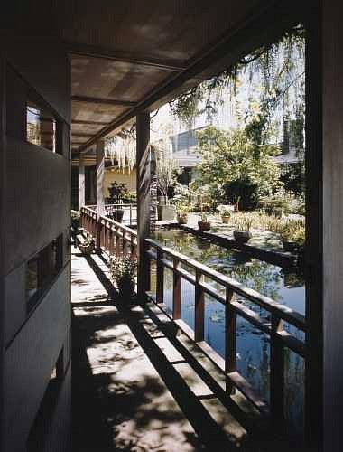 A door in the fir-paneled exterior wall separates the driveway from the tranquil courtyard within. Photograph by ESTO