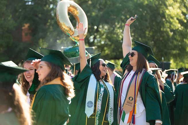 Graduates celebrating during the Duck Grad Parade