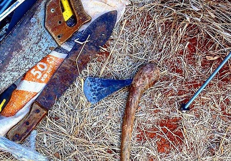 A bloody hatchet and machete