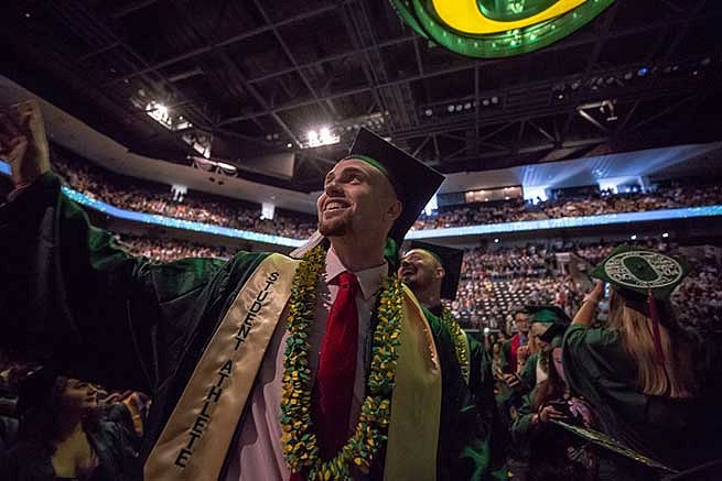 Student waves to the crowd looking for family members