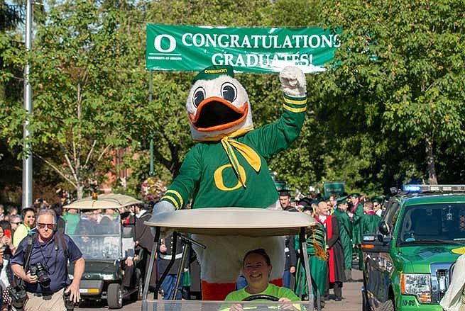 The Duck proudly leads the graduates to the commencement ceremony