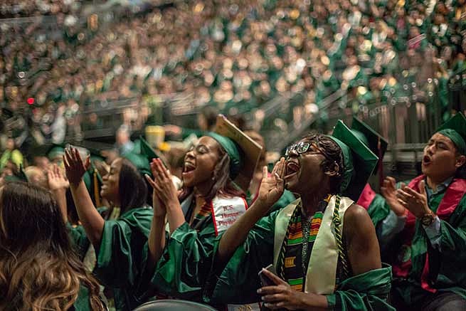 Students cheer for the commencement speakers