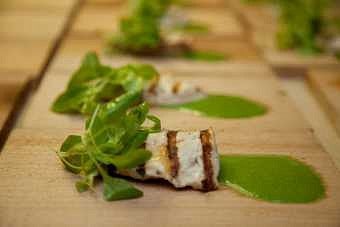Cedar-paper grilled sturgeon with wild greens