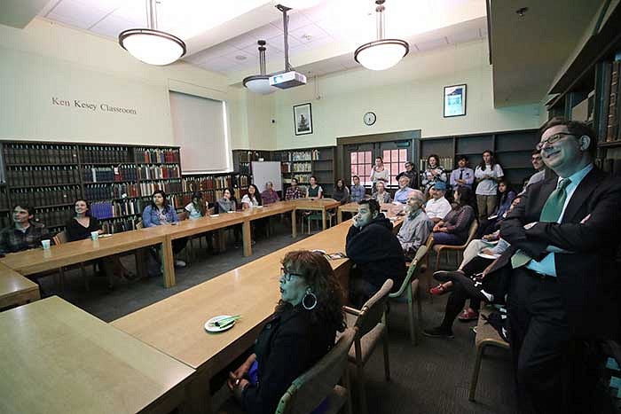 President Michael Schill watching videos in Ken Kesey classroom