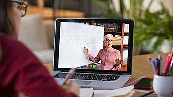 Student watching class on a computer