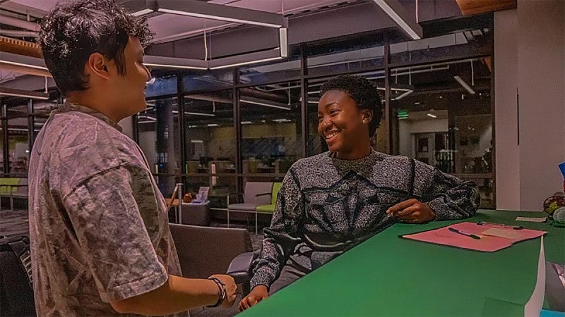 Valerie Owusu-Hienno talking with a fellow student