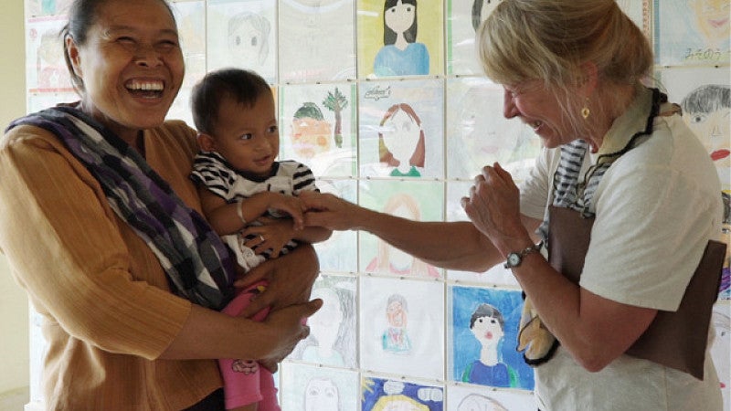 Geri Richmond meeting with a woman and her child