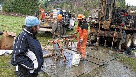 Jill Marshall watches as workers operate drilling equipment
