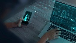 computer laptop screen and a mobile phone with symbols of a key lock displayed