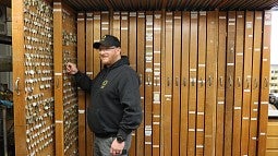 Steve Seeley in front of key cabinets