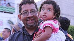 Pablo Hernandez Reyes holding daughter