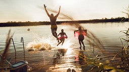people jumping into lake
