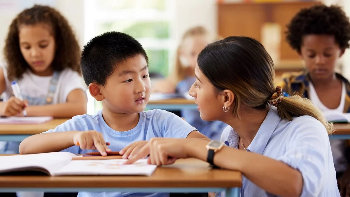 Teacher helping student read