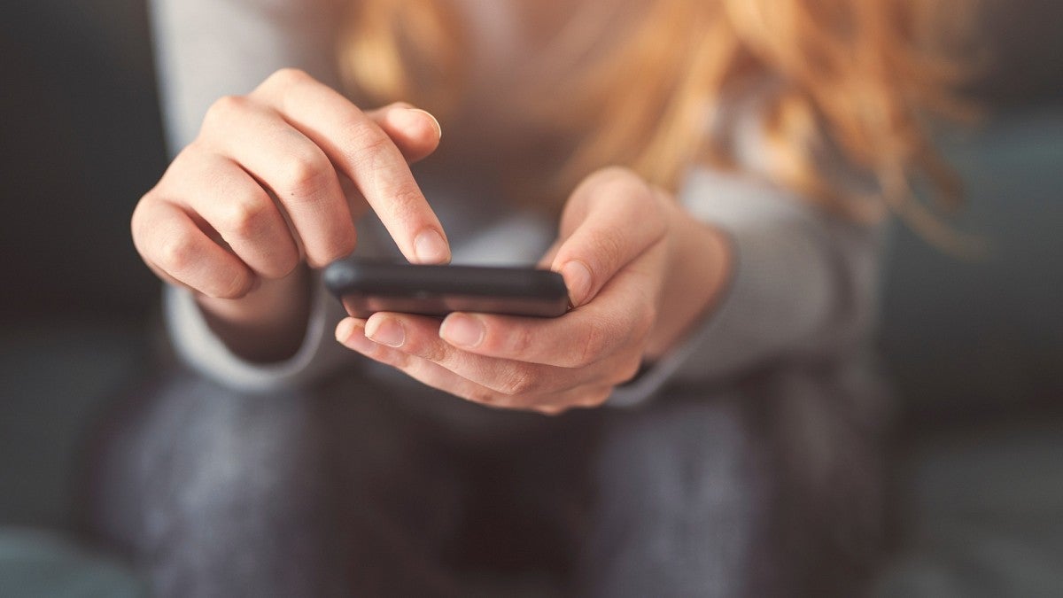 hands using cell phone