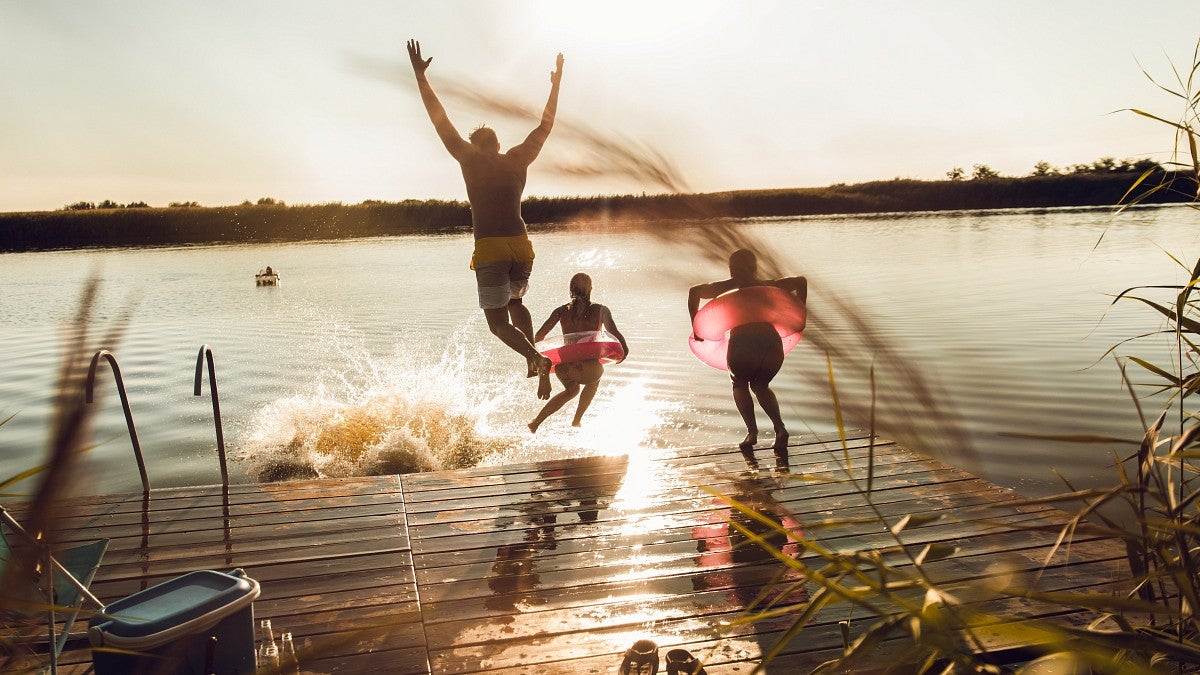 people jumping into lake