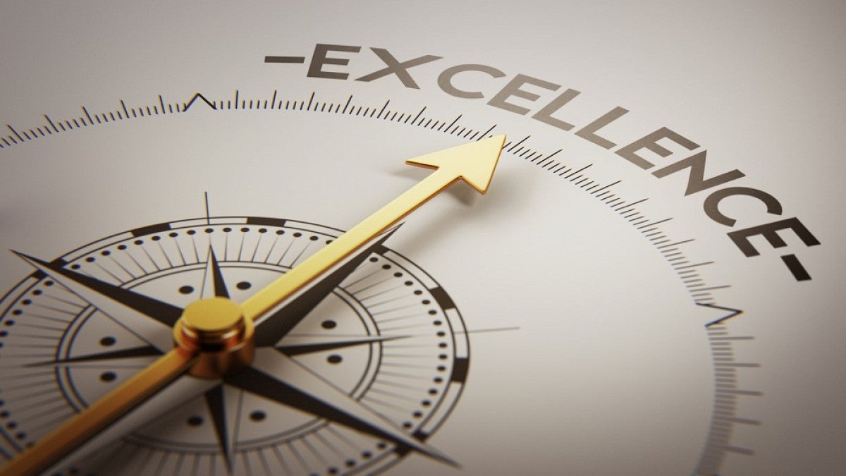 Image of compass pointing to word Excellence