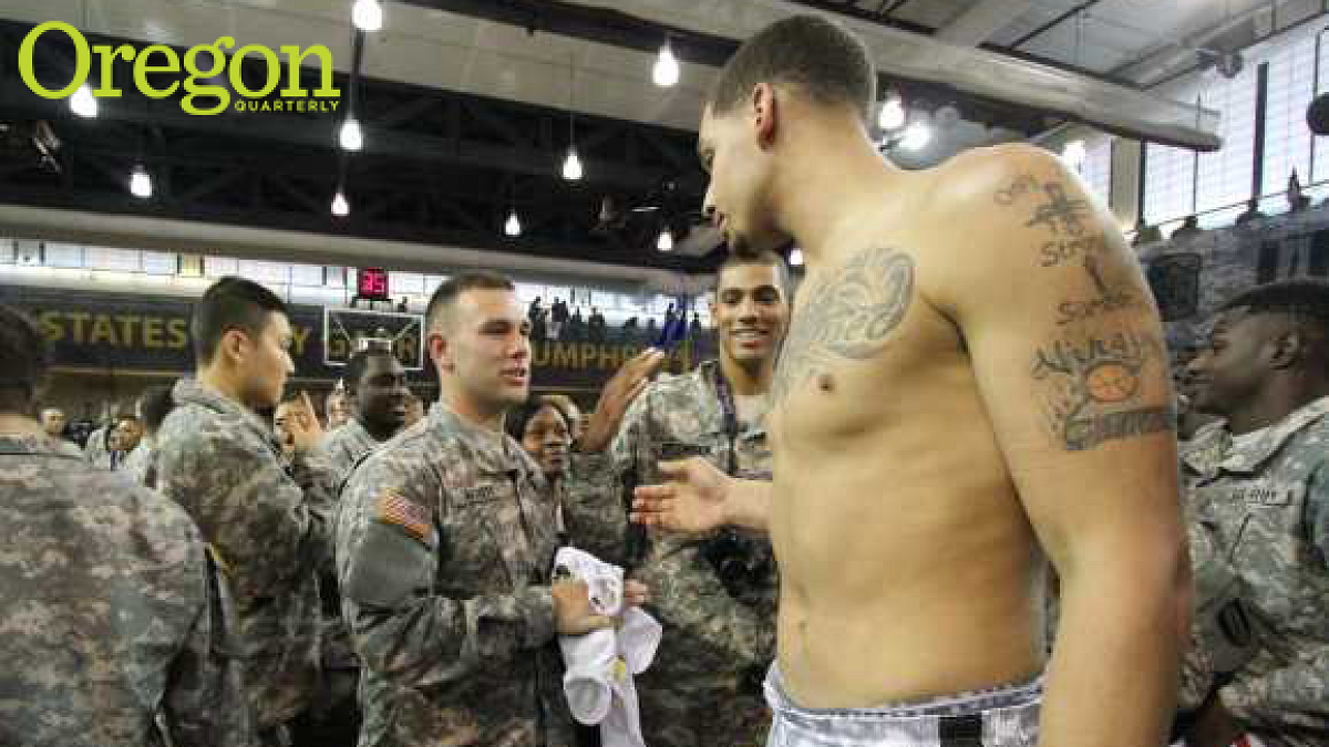 6'11" senior center Waverly Austin gives his jersey to a soldier. Photograph by Deirdre Shean Kanzig '83