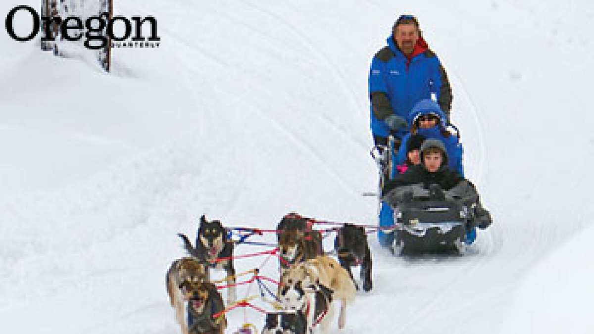 Jerry Scdoris runs a team of sled dogs through a snowy forest at Mount Bachelor. Photograph courtesy Jay Mather Photography