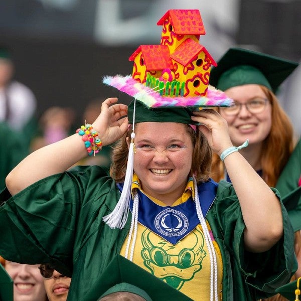 grad woman with house on her cap