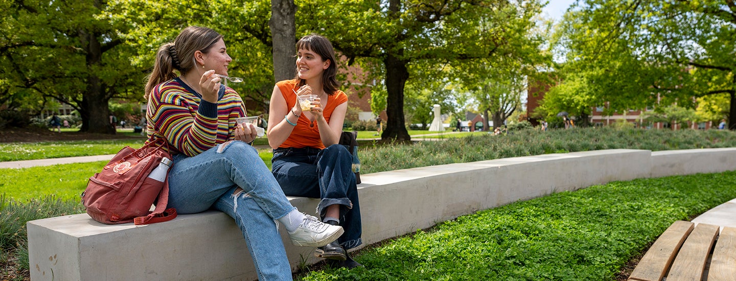 Students sit in the sun and enjoy a frozen treat
