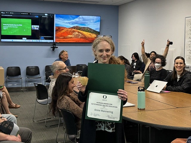 anne mannering holding award certificate