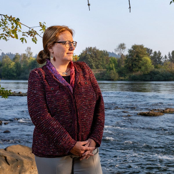 adell amos standing next to river