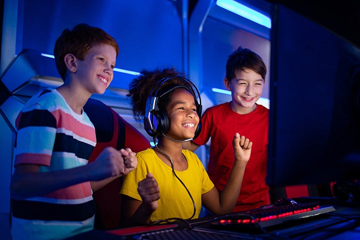 Three young teenagers play esports