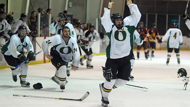 Students in Hockey Club playing on ice.