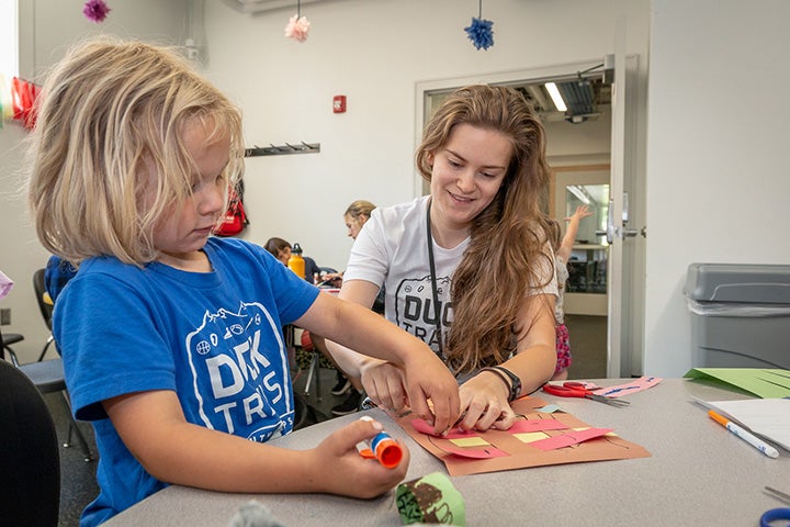 Child participating in arts and crafts.