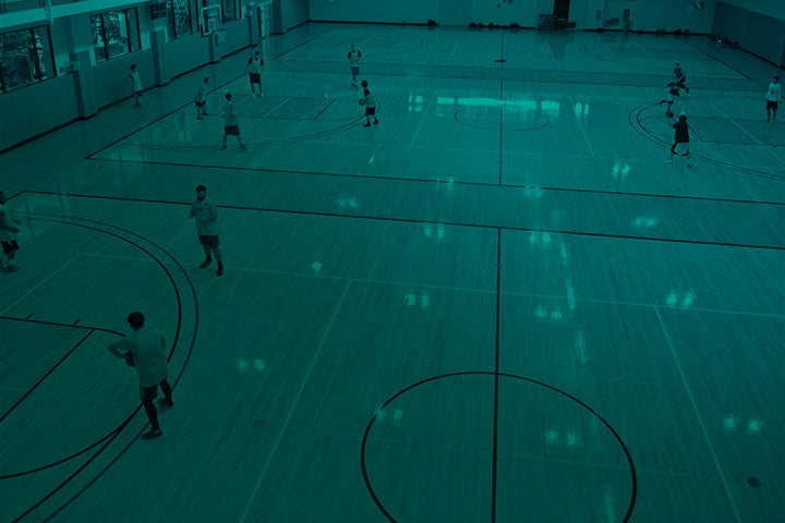 Students playing indoor basketball.