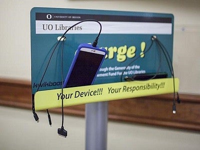 Phones charging at charging station