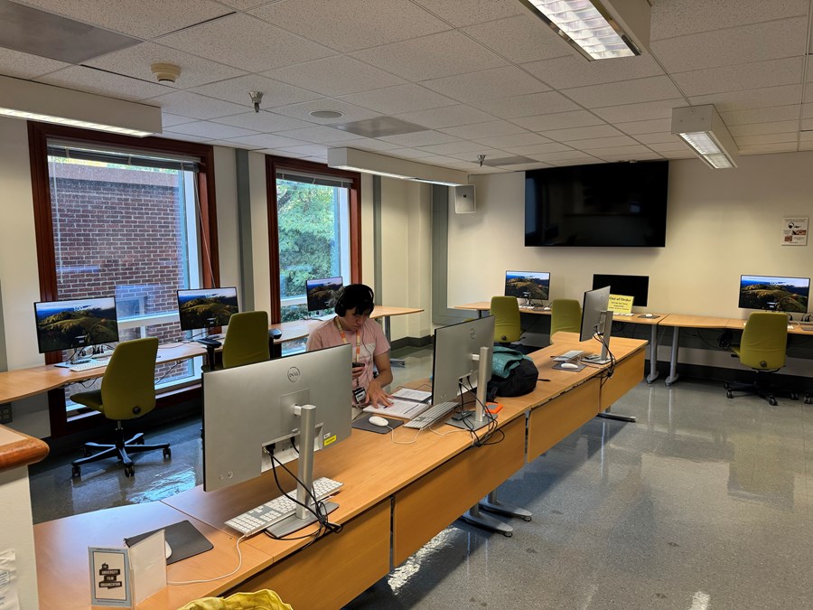 The Cinema Studies Classroom with PCs on desks with rolling chairs