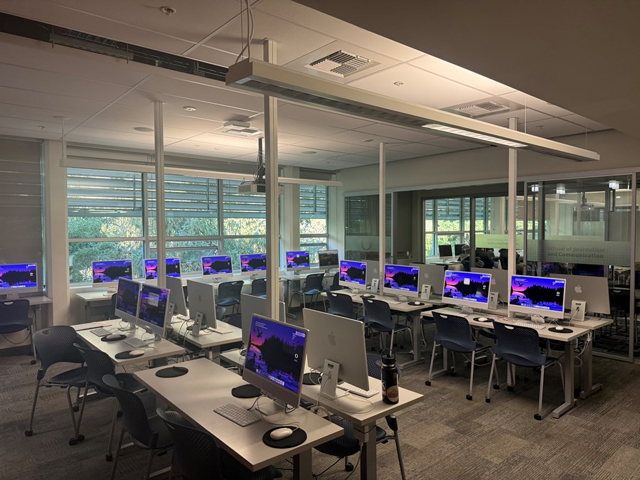 Allen 302 with computers on desks and windows against the back wall
