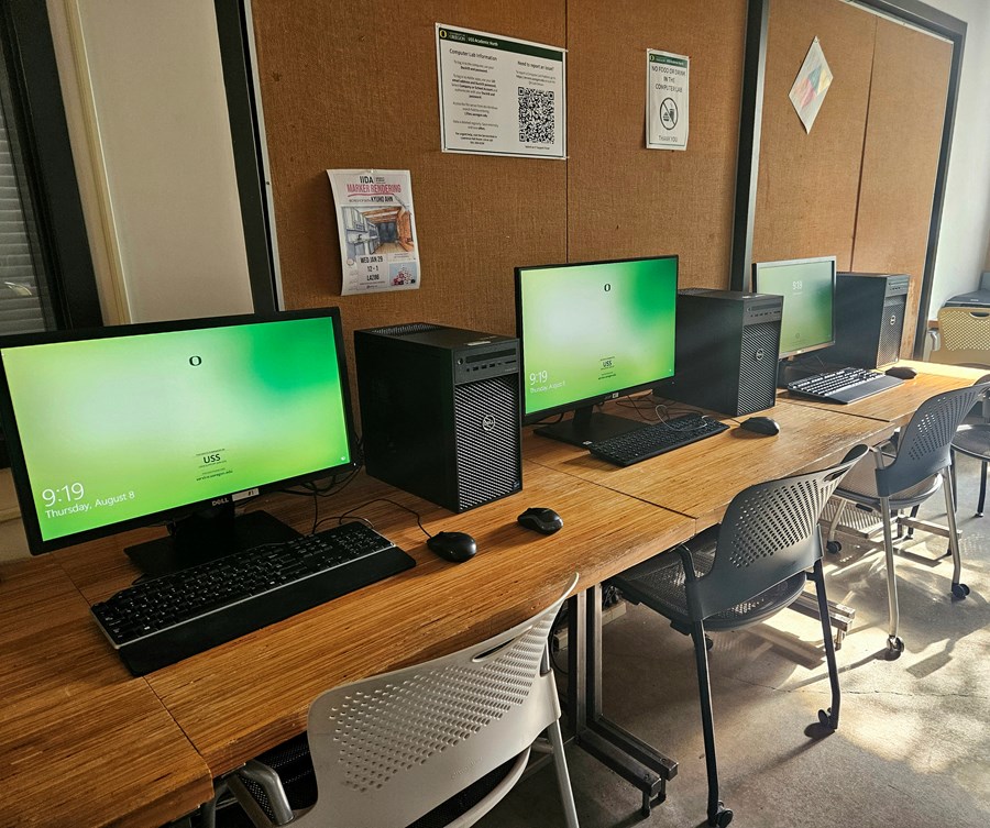 Close up of two lab computer setups, each with a monitor, keyboard, and mouse.