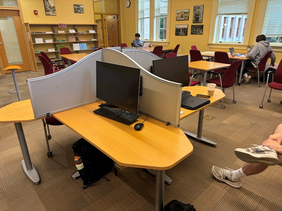 Two computers on desks with privacy screens within the Math library