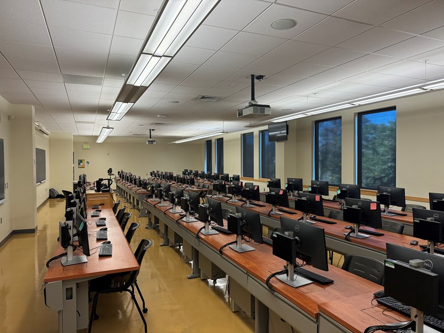 Image of Chiles 225 from the front, with computers on desks with rolling chairs