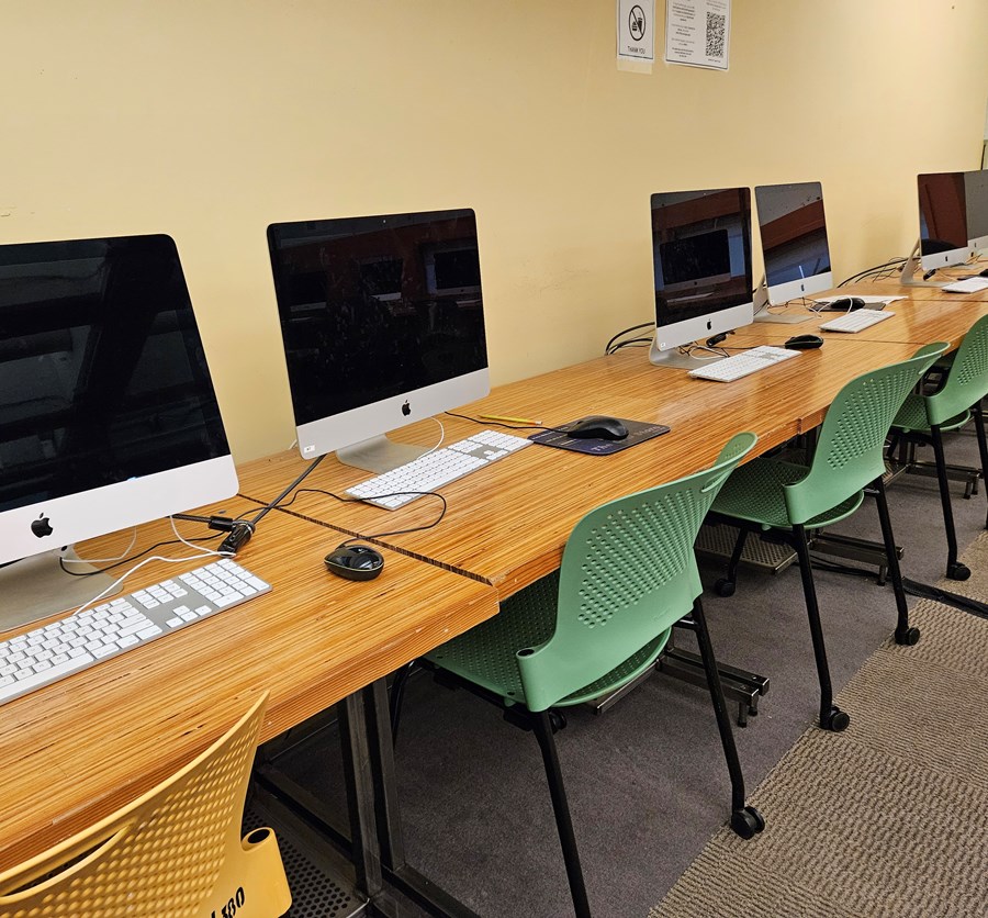 Wide view of computer lab stations against the wall in the Lawrence Room 283 computer lab.