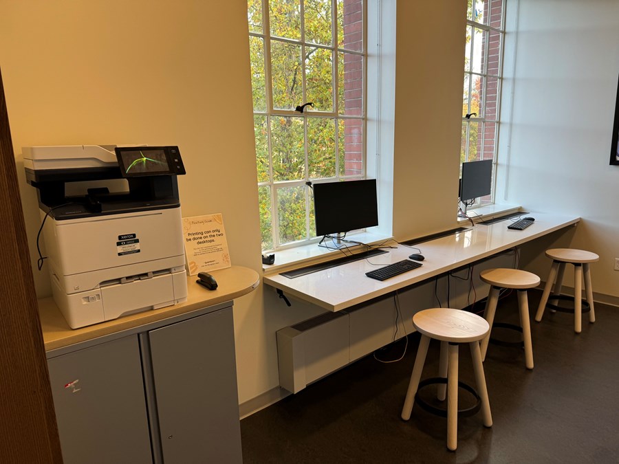 Chapman 305 print station with computers on a long desk with stools and a printer to the left